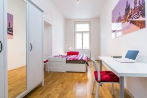 Bedroom with one bed, closet, and desk